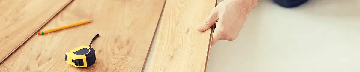 A professional installing wood flooring in Honolulu, HI